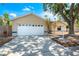 Charming one-story home featuring an attached garage, mature landscaping, and a welcoming front porch at 5623 Wilde Oak Way, Sarasota, FL 34232