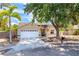 Charming one-story home featuring an attached garage, mature landscaping, and a welcoming front porch at 5623 Wilde Oak Way, Sarasota, FL 34232
