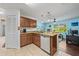 Modern kitchen featuring wood cabinetry and plenty of countertop space with access to the office at 5623 Wilde Oak Way, Sarasota, FL 34232