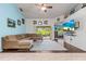 Bright living room featuring a comfortable sofa, entertainment center with a TV, and a sliding glass door to the patio at 5623 Wilde Oak Way, Sarasota, FL 34232