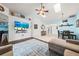 Spacious living room with hardwood floors, ceiling fan, and an entertainment center at 5623 Wilde Oak Way, Sarasota, FL 34232