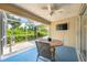 Relaxing screened patio with a ceiling fan and outdoor seating, great for entertaining and unwinding at 5623 Wilde Oak Way, Sarasota, FL 34232