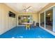 Cozy screened patio with tile table, fan, and sliding doors providing easy access to indoor and outdoor spaces at 5623 Wilde Oak Way, Sarasota, FL 34232