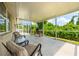 Relaxing covered and screened patio with comfortable seating, ideal for relaxation and enjoying the lush landscaping at 5623 Wilde Oak Way, Sarasota, FL 34232