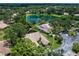 Aerial view of a beautiful home with a private backyard overlooking a serene lake surrounded by lush greenery at 5729 Garden Lakes Palm, Bradenton, FL 34203