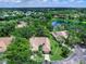 Aerial view of property showcasing lush landscaping, private pool, and serene water views at 5729 Garden Lakes Palm, Bradenton, FL 34203