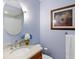 Charming bathroom with a soft color palette, vanity, and round mirror, creating a serene and inviting space at 5729 Garden Lakes Palm, Bradenton, FL 34203