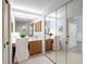 Bathroom featuring a vanity area with plenty of mirrored closet space at 5729 Garden Lakes Palm, Bradenton, FL 34203