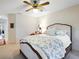 Bright bedroom featuring a cozy bed and carpet, with a view into the living room at 5729 Garden Lakes Palm, Bradenton, FL 34203