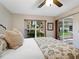 Cozy bedroom with a view of lush greenery, featuring a slider to the screened patio at 5729 Garden Lakes Palm, Bradenton, FL 34203