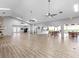 Spacious common area featuring a fireplace, kitchen, wood floors, ceiling fans, and seating at 5729 Garden Lakes Palm, Bradenton, FL 34203