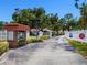 Gated entrance to a 55+ community with well-maintained landscaping and clear signage at 5729 Garden Lakes Palm, Bradenton, FL 34203