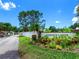 Entrance to the Garden Lakes Community featuring a beautiful sign surrounded by colorful landscaping at 5729 Garden Lakes Palm, Bradenton, FL 34203