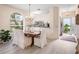 Bright dining area with natural light, white slip-covered chairs, and views to living area at 5729 Garden Lakes Palm, Bradenton, FL 34203