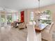 Open-concept dining area with chandelier, light floors, and views of the outdoor patio at 5729 Garden Lakes Palm, Bradenton, FL 34203