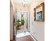 Light-filled entryway with rug and view of well-maintained garden through a white framed glass door at 5729 Garden Lakes Palm, Bradenton, FL 34203