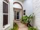 Welcoming front entrance with beautiful landscaping and a charming walkway leading to the front door at 5729 Garden Lakes Palm, Bradenton, FL 34203