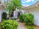 Inviting front entrance with lush landscaping and a charming walkway leading to the front door of this beautiful home at 5729 Garden Lakes Palm, Bradenton, FL 34203