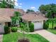 Charming single-Gathering home with a well-manicured lawn, landscaped front yard, and attached garage at 5729 Garden Lakes Palm, Bradenton, FL 34203