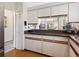 Bright kitchen features white cabinets, and hardwood floors leading to other parts of the home at 5729 Garden Lakes Palm, Bradenton, FL 34203