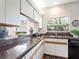A light and bright kitchen offers granite countertops and lots of cabinet space at 5729 Garden Lakes Palm, Bradenton, FL 34203