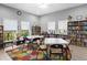 Inviting library with built-in bookshelves, cozy seating, and tranquil garden views at 5729 Garden Lakes Palm, Bradenton, FL 34203