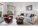 Cozy living room featuring a large window, comfortable seating, and stylish decor at 5729 Garden Lakes Palm, Bradenton, FL 34203