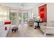 Bright living room with light wood floors, neutral furniture, and a view of the outdoor patio at 5729 Garden Lakes Palm, Bradenton, FL 34203