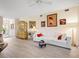 Bright living room with a light color scheme, neutral flooring, and a collection of framed art pieces at 5729 Garden Lakes Palm, Bradenton, FL 34203