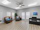 Serene sitting room with comfortable seating, piano, and natural light from the windows at 5729 Garden Lakes Palm, Bradenton, FL 34203