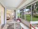 Bright sunroom with large windows, tile flooring, and views of the landscaped yard, perfect for relaxation at 5729 Garden Lakes Palm, Bradenton, FL 34203