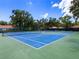 Well-maintained community tennis courts with green and blue surface, surrounded by mature trees at 5729 Garden Lakes Palm, Bradenton, FL 34203