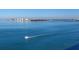 Scenic waterfront view featuring a boat sailing on clear blue water with a cityscape in the distance at 5729 Garden Lakes Palm, Bradenton, FL 34203