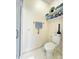 Bright bathroom featuring shelves, a toilet, and a walk-in shower with glass door at 5810 Garden Lakes Palm, Bradenton, FL 34203