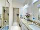 Bathroom featuring double sinks with granite countertops and a glass-enclosed shower at 5810 Garden Lakes Palm, Bradenton, FL 34203
