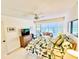 Comfortable bedroom with a ceiling fan and a view of the backyard through bay windows at 5810 Garden Lakes Palm, Bradenton, FL 34203