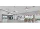 Open clubhouse with seating, refreshment area, and views of the exterior landscape through bright windows at 5810 Garden Lakes Palm, Bradenton, FL 34203
