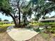 Serene community park with shaded benches and paved walkways for relaxing strolls at 5810 Garden Lakes Palm, Bradenton, FL 34203