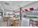 Community area for socializing, featuring tables, chairs, a kitchen, and large windows with scenic views at 5810 Garden Lakes Palm, Bradenton, FL 34203
