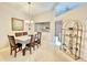 Bright dining room with a table set for six, a display cabinet, and ample natural light at 5810 Garden Lakes Palm, Bradenton, FL 34203