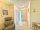 Welcoming entryway with tile flooring, featuring a cozy chair and a closet for added convenience at 5810 Garden Lakes Palm, Bradenton, FL 34203