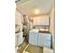 Functional laundry room with modern washer and dryer units and ample storage space at 5810 Garden Lakes Palm, Bradenton, FL 34203