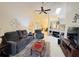 Cozy living room with comfortable seating, a ceiling fan, and plenty of natural light at 5810 Garden Lakes Palm, Bradenton, FL 34203