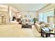 Spacious living room with neutral tones and comfortable seating, bathed in natural light from a big window at 5810 Garden Lakes Palm, Bradenton, FL 34203