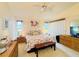 Bright main bedroom featuring a ceiling fan, natural light, and ample closet space at 5810 Garden Lakes Palm, Bradenton, FL 34203