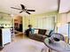 Inviting sunroom with comfortable seating and a ceiling fan providing a relaxing space at 5810 Garden Lakes Palm, Bradenton, FL 34203
