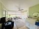 Cozy sunroom with views of the property featuring a ceiling fan and comfortable seating area at 5810 Garden Lakes Palm, Bradenton, FL 34203