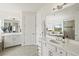 Luxurious bathroom featuring double vanity, large mirrors, and soaking tub with scenic views at 5823 Title Row Dr, Bradenton, FL 34210