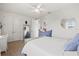Well-lit bedroom with white ceiling fan, double door closet, and comfortable decor at 5823 Title Row Dr, Bradenton, FL 34210