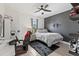 Nicely decorated bedroom with gray accent wall, desk, and ceiling fan at 5823 Title Row Dr, Bradenton, FL 34210